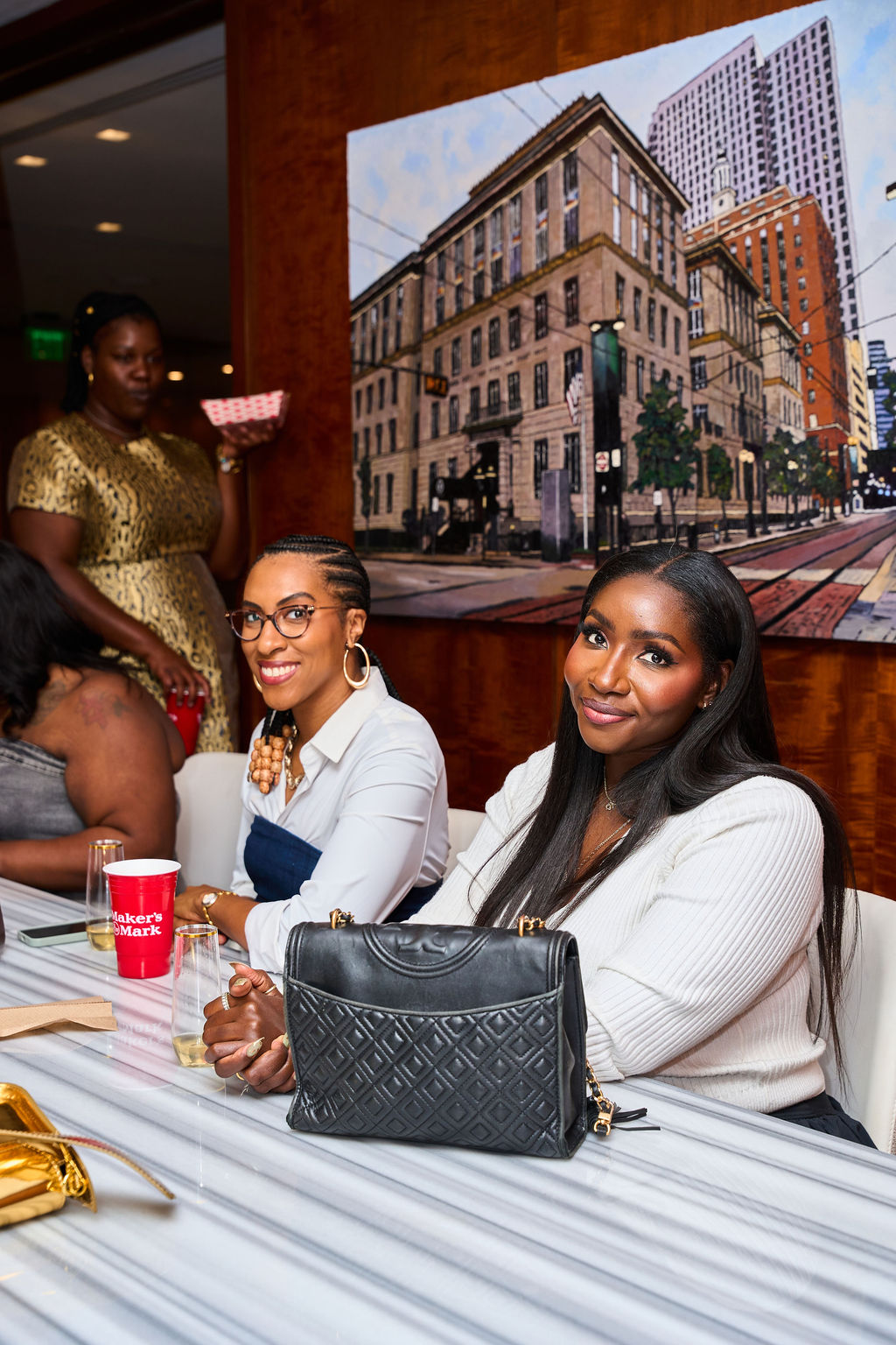 Guests seated at a table enjoying drinks at Dinner Society Vibesgiving